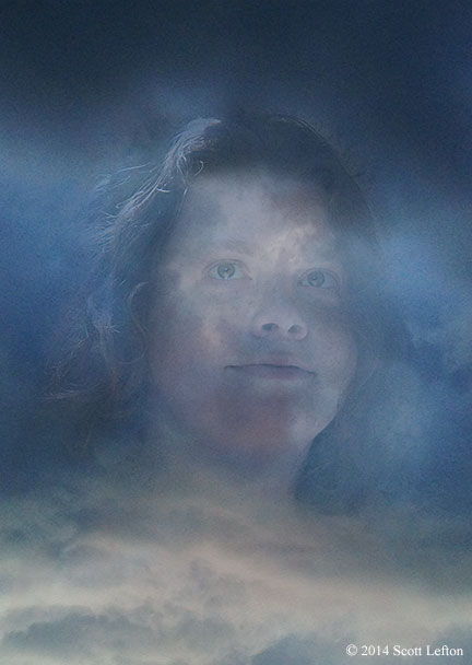 A woman's face is seen in a mass of storm clouds.