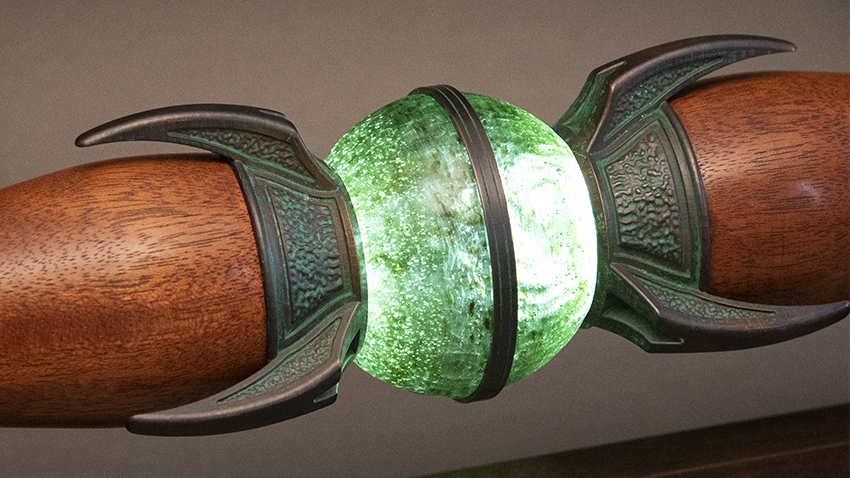 A detailed view of the Scepter center glass sphere, glowing green.