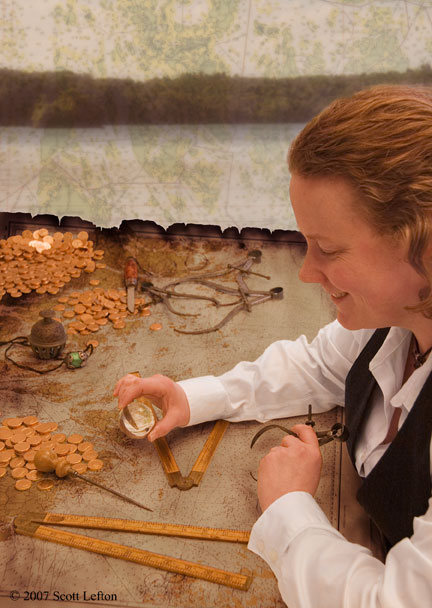 Fulfillment - A well dressed person sits in front of an old and battered map, its surface scattered with riches and measuring instruments.  They contemplate a small crystal ball with an expression of deep satisfaction. 