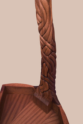 Details of the underside showing the carved tendrils continuing around the back and the veneered underside of the tabletop